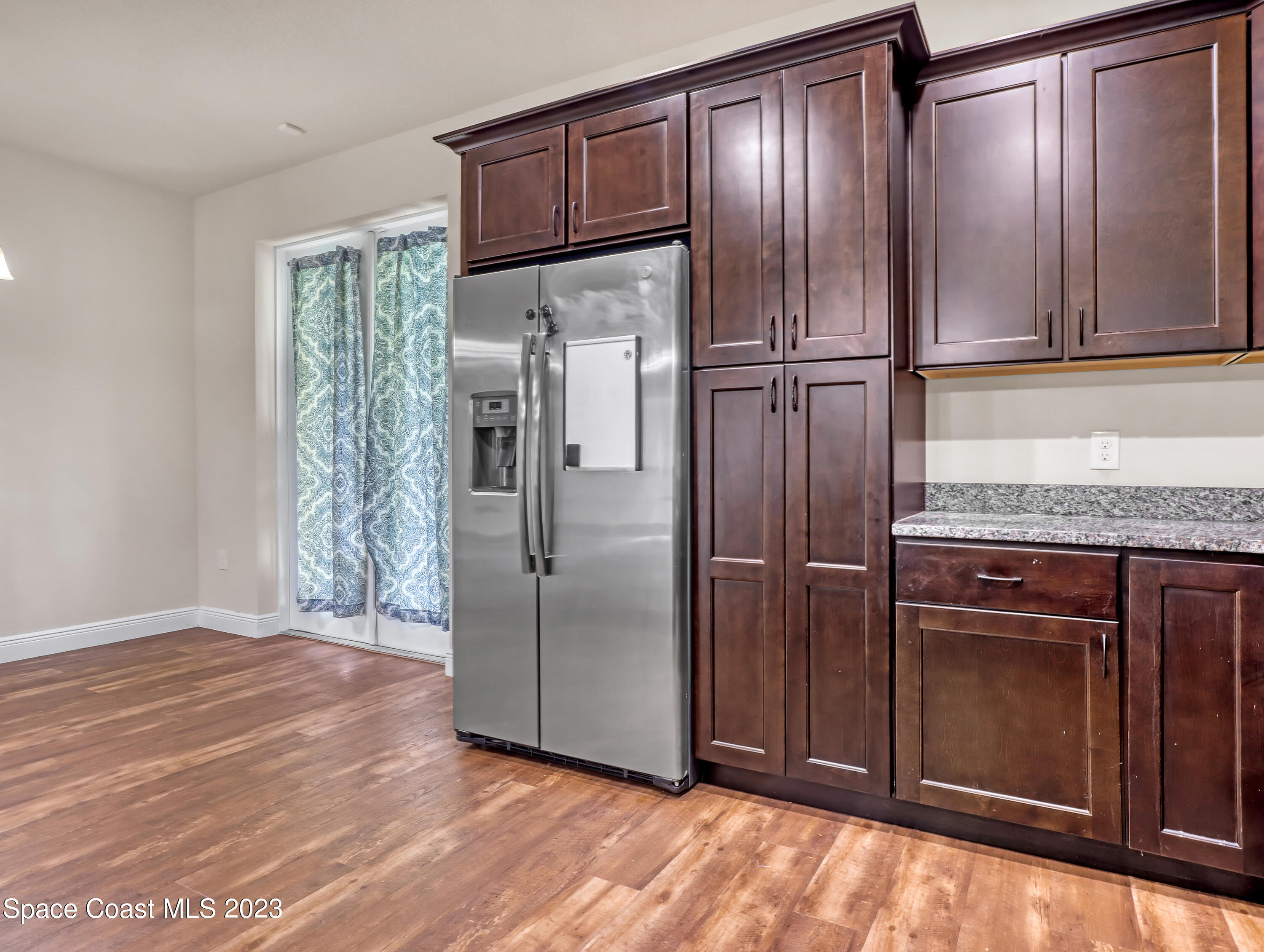 1310 Gaucho Road Southwest Palm Bay, FL 32908 - Photo 16 of 32 a kitchen with granite countertop stainless steel appliances a refrigerator and cabinets