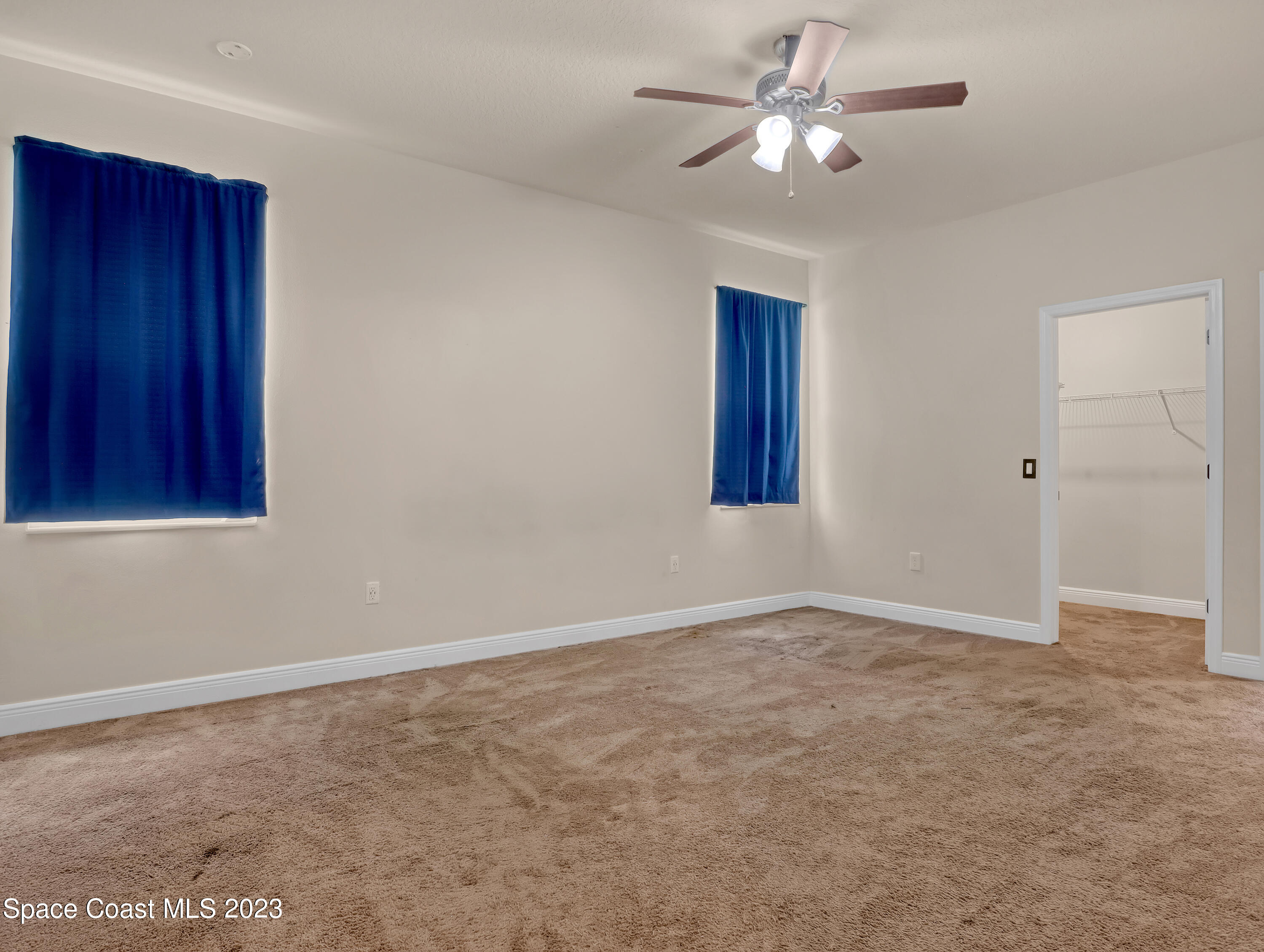 1310 Gaucho Road Southwest Palm Bay, FL 32908 - Photo 17 of 32 a view of an empty room and a ceiling fan