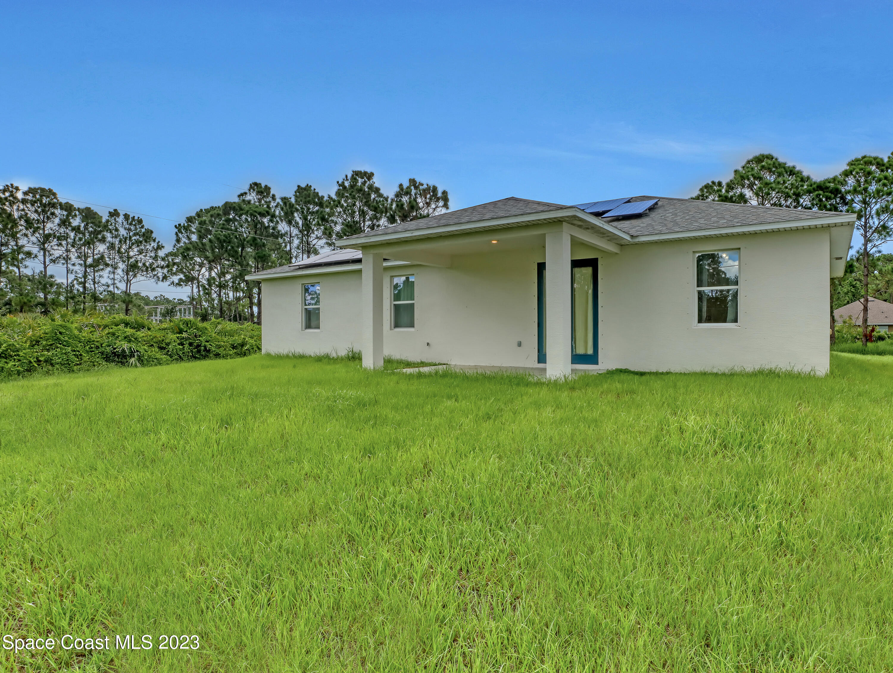 1310 Gaucho Road Southwest Palm Bay, FL 32908 - Photo 29 of 32 a view of a house with a yard