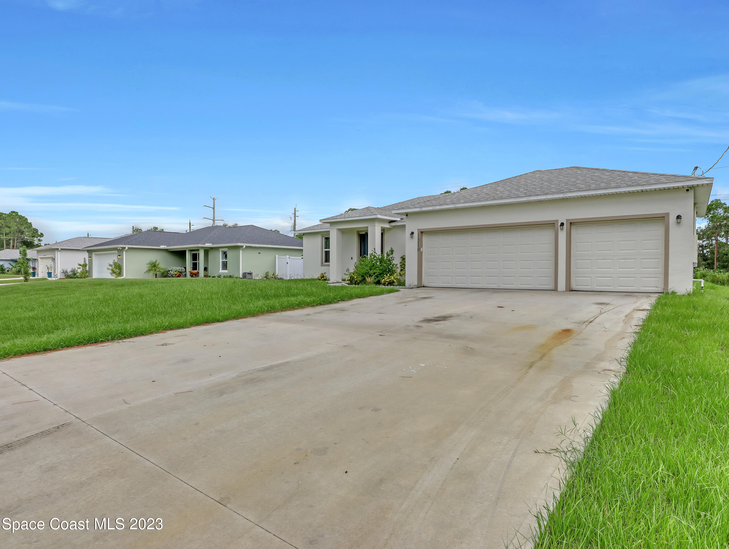 1310 Gaucho Road Southwest Palm Bay, FL 32908 - Photo 5 of 32 a front view of house with yard and green space