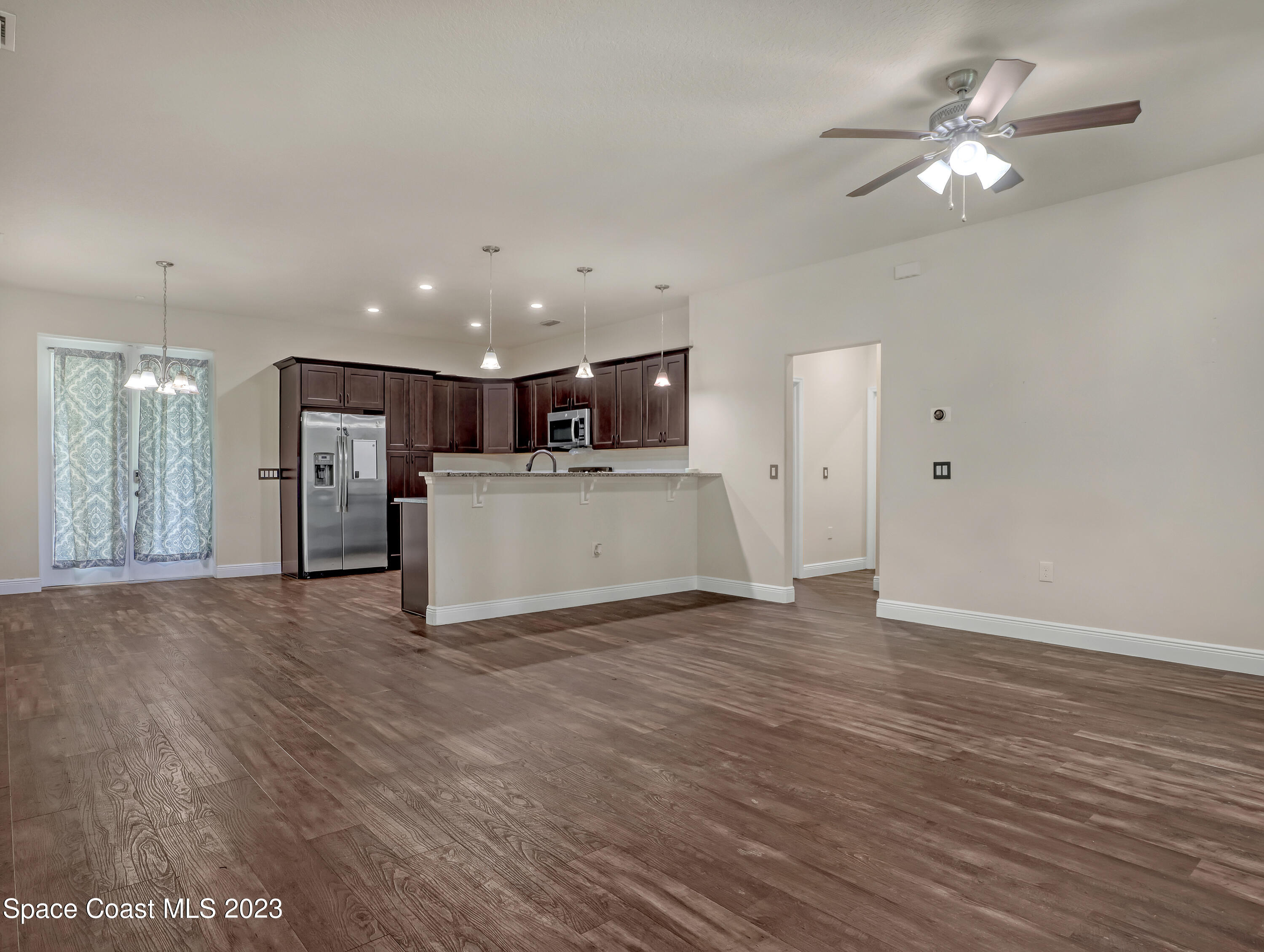 1310 Gaucho Road Southwest Palm Bay, FL 32908 - Photo 8 of 32 a view of a kitchen with a sink and a refrigerator