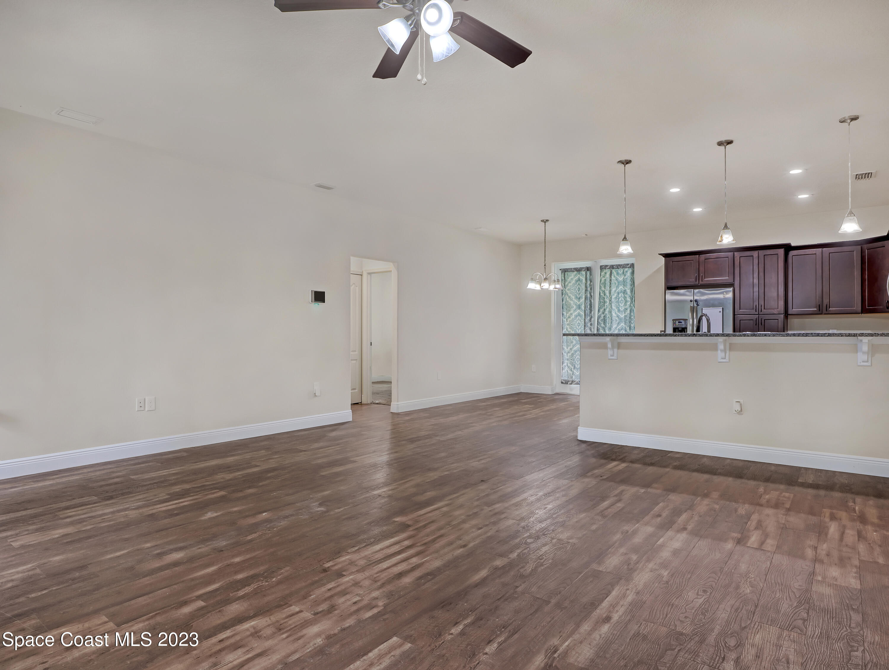 1310 Gaucho Road Southwest Palm Bay, FL 32908 - Photo 10 of 32 a view of kitchen with granite countertop cabinets and refrigerator