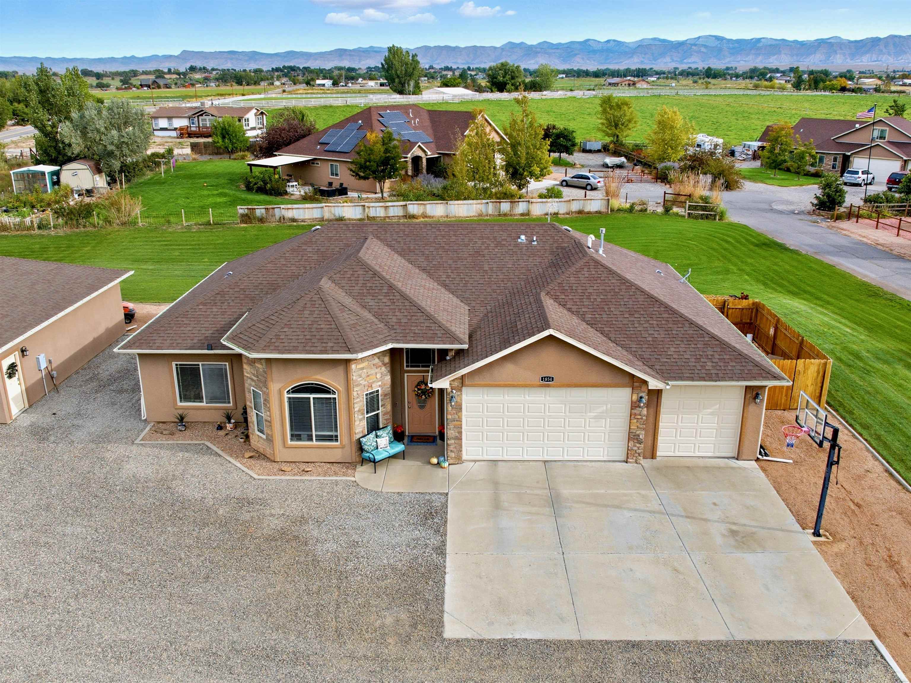 1850 Golden Ranch Road Fruita, CO 81521 - Photo 1 of 39 an aerial view of a house with big yard and large tree