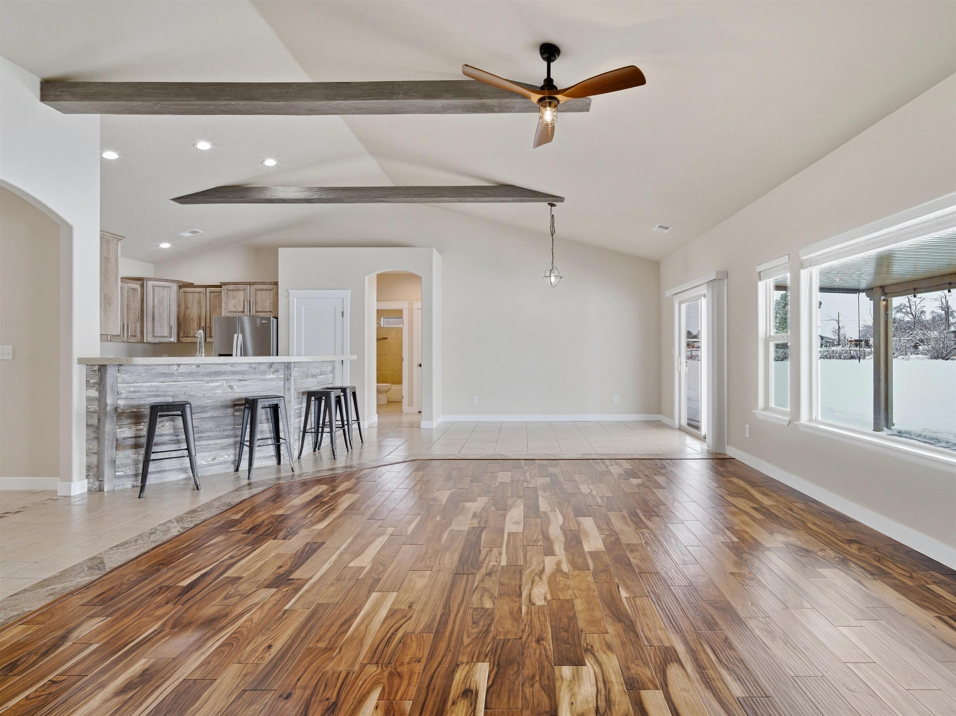 1850 Golden Ranch Road Fruita, CO 81521 - Photo 11 of 39 a view of a room with wooden floor a ceiling fan and windows