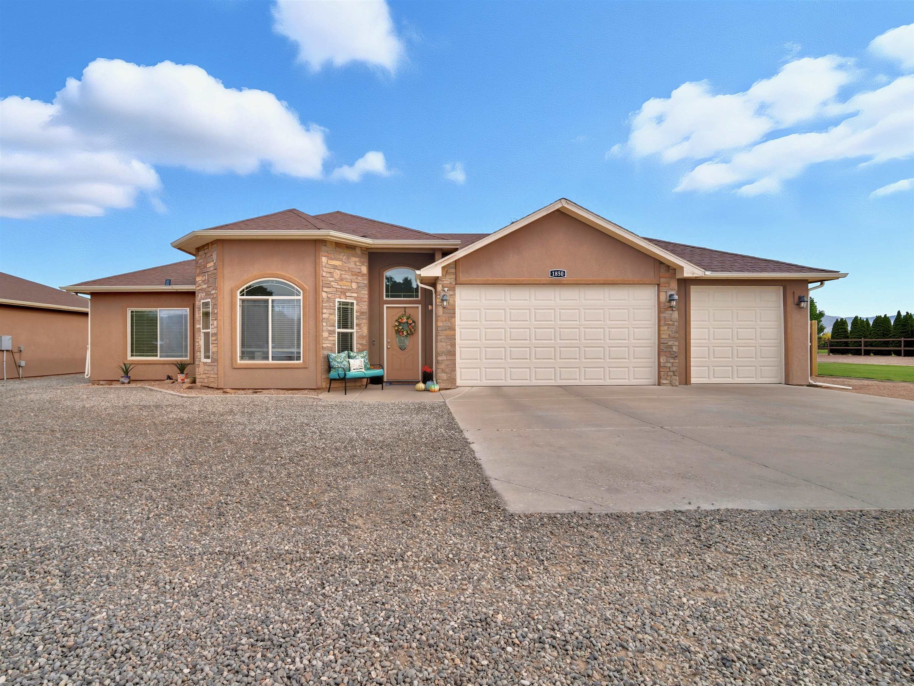 1850 Golden Ranch Road Fruita, CO 81521 - Photo 2 of 39 a front view of a house with a yard and garage