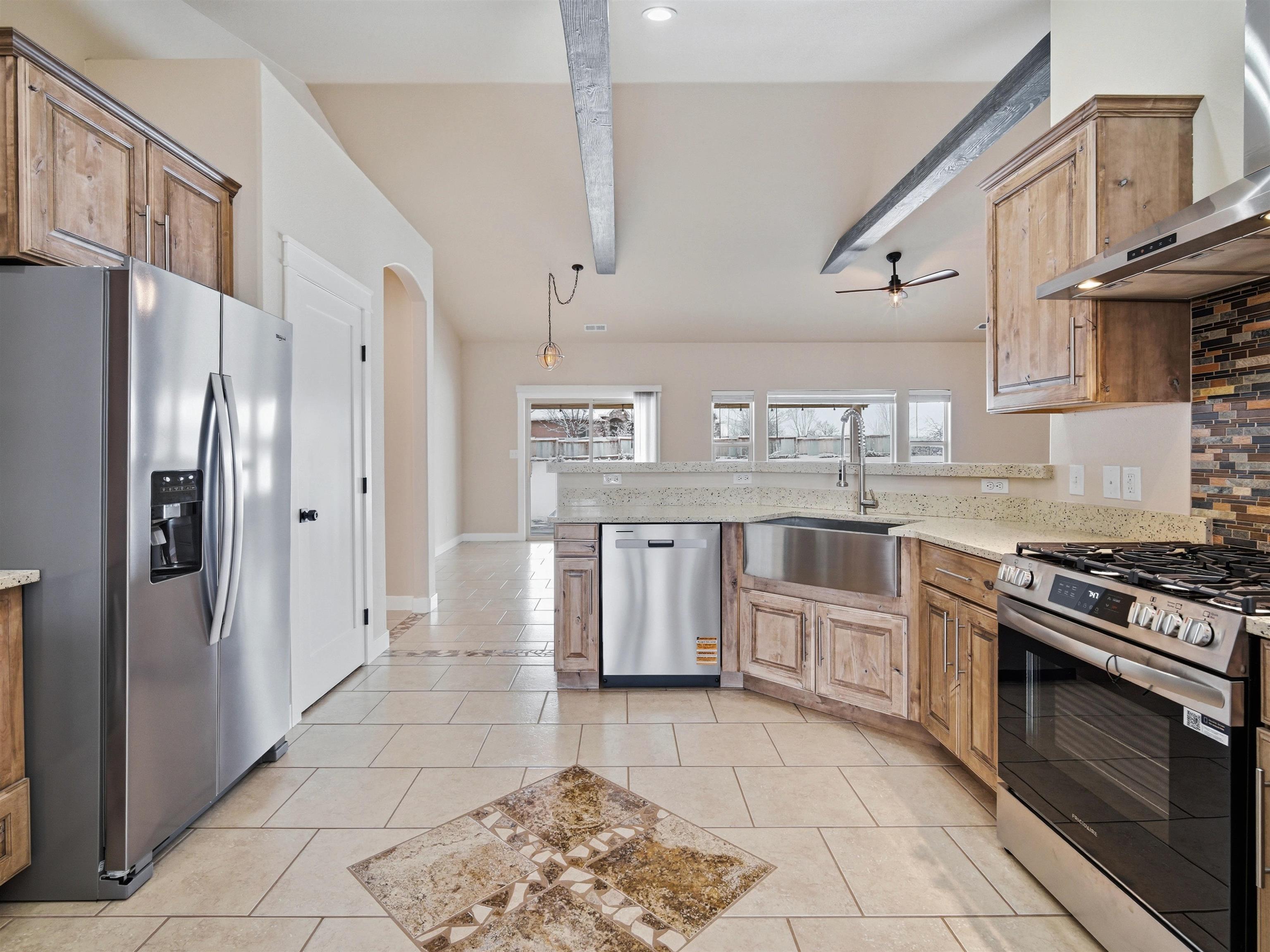 1850 Golden Ranch Road Fruita, CO 81521 - Photo 3 of 39 a kitchen with stainless steel appliances granite countertop a stove a refrigerator and a cabinets