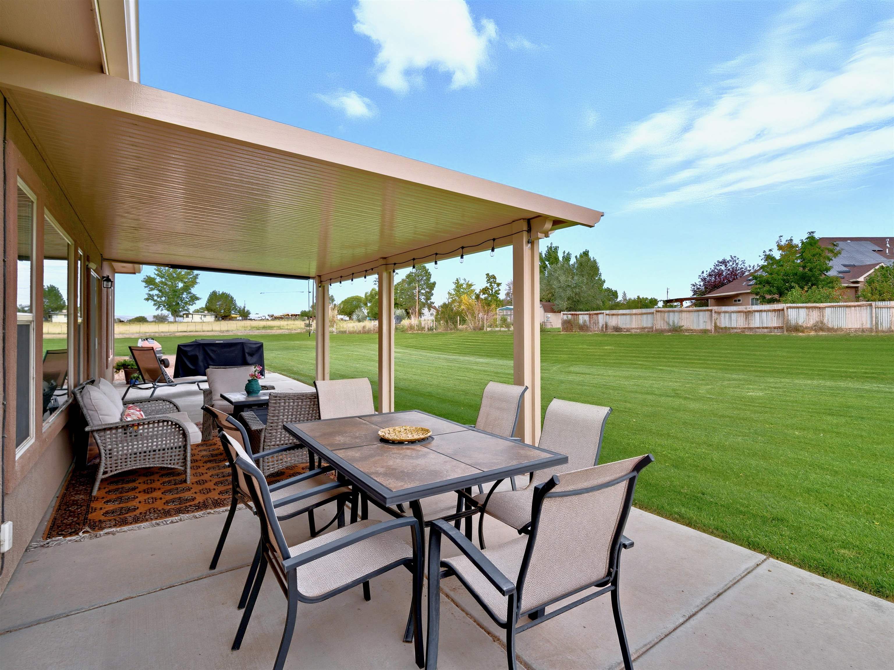 1850 Golden Ranch Road Fruita, CO 81521 - Photo 32 of 39 a view of a patio with a table chairs and a backyard