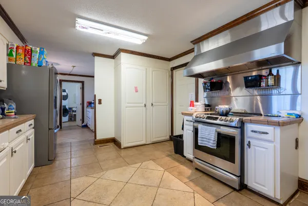 a kitchen with stainless steel appliances granite countertop a stove and a refrigerator