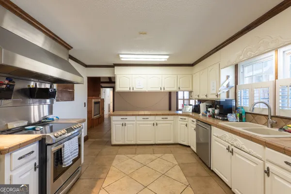 a kitchen with stainless steel appliances granite countertop a stove and a sink