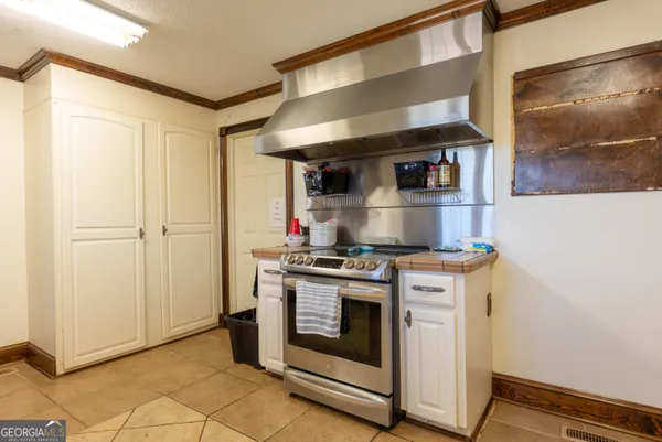 a kitchen with stainless steel appliances granite countertop a stove and a refrigerator