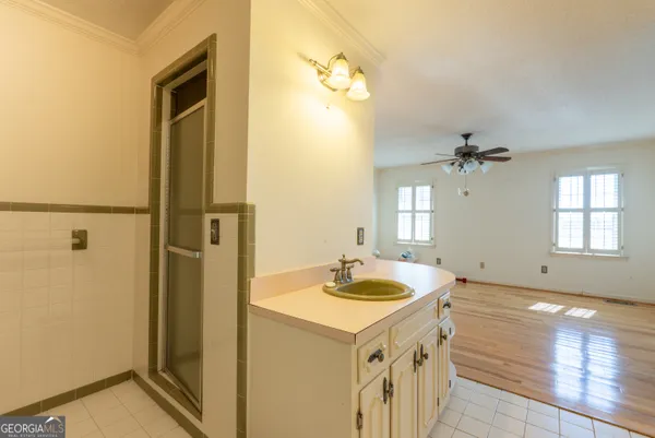 a bathroom with a sink a mirror and a shower