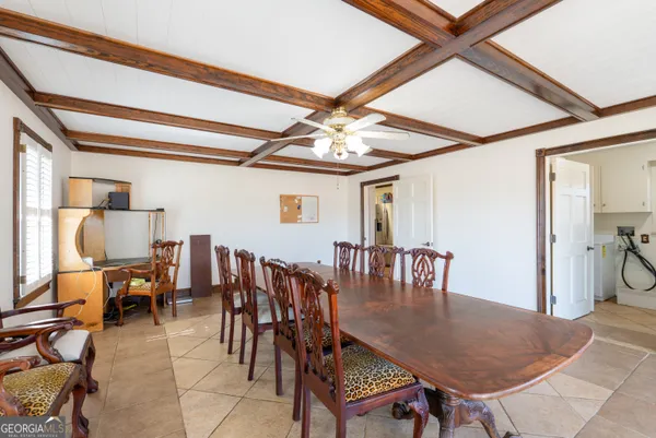 a dining room with furniture and window