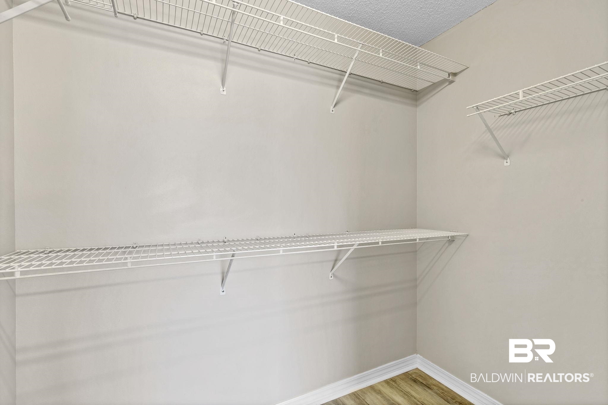 10238 Grove Drive Fairhope, AL 36532 - Photo 21 of 39 Primary Bathroom with 2 closets, a garden tub, separate shower, private water closet, wood finished floors, and double vanity.