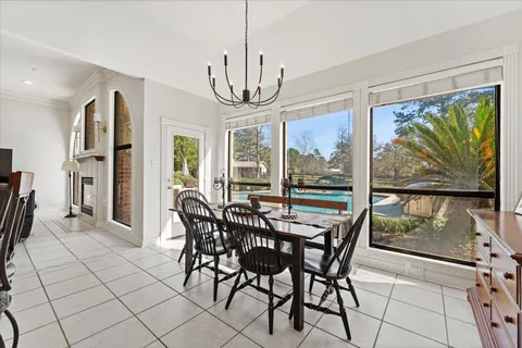 a living room with furniture a fireplace and a chandelier