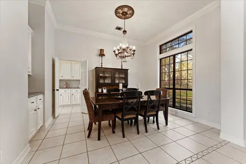 a view of a dining room with furniture and chandelier