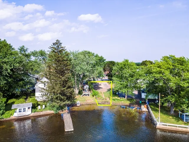 a view of a lake with couches and a table and chairs