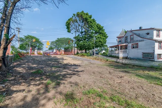 a view of a road with a house in the background