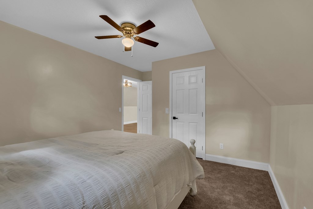 152 Parker Road Sparta, TN 38583 - Photo 13 of 30 a spacious bedroom with a bed and a ceiling fan