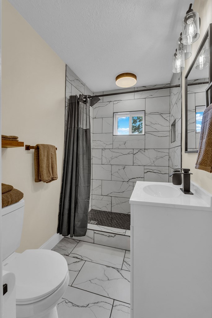 152 Parker Road Sparta, TN 38583 - Photo 18 of 30 a bathroom with a sink a toilet and shower