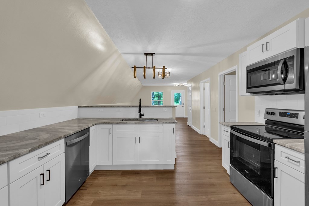 152 Parker Road Sparta, TN 38583 - Photo 5 of 30 a kitchen with stainless steel appliances granite countertop a stove a sink and a microwave