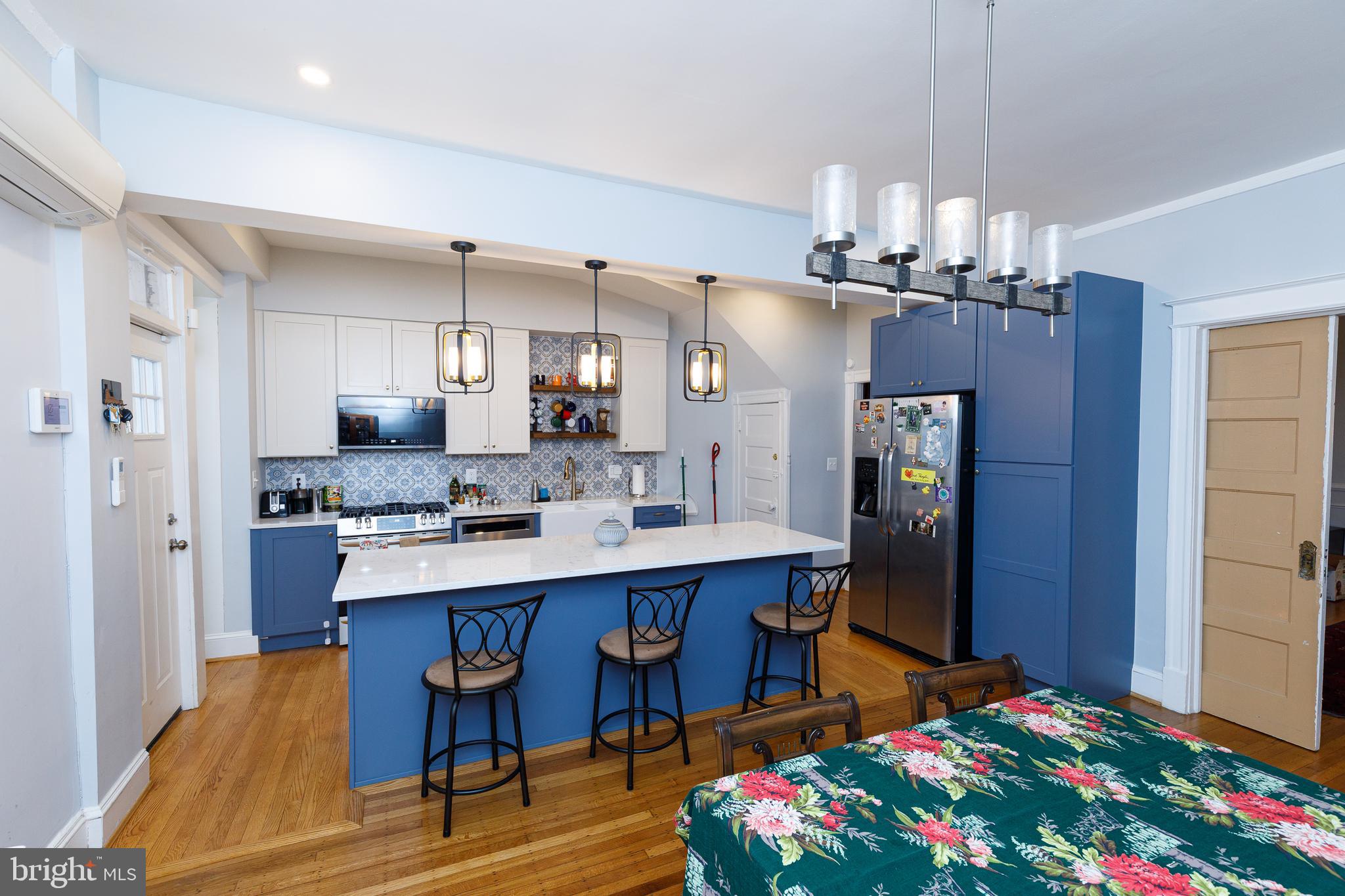 1113 Clifton Street Northwest Washington, DC 20009 - Photo 13 of 44 a large kitchen with a table and chairs