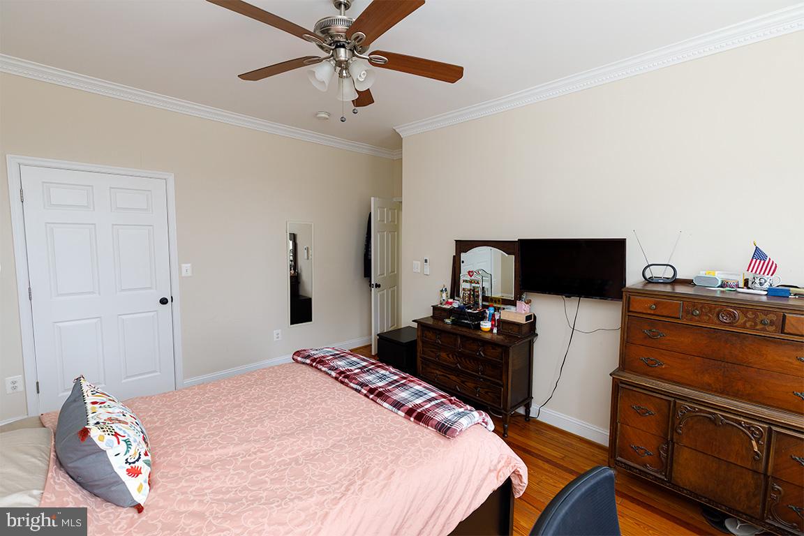 1113 Clifton Street Northwest Washington, DC 20009 - Photo 26 of 44 a bedroom with a bed and a flat screen tv