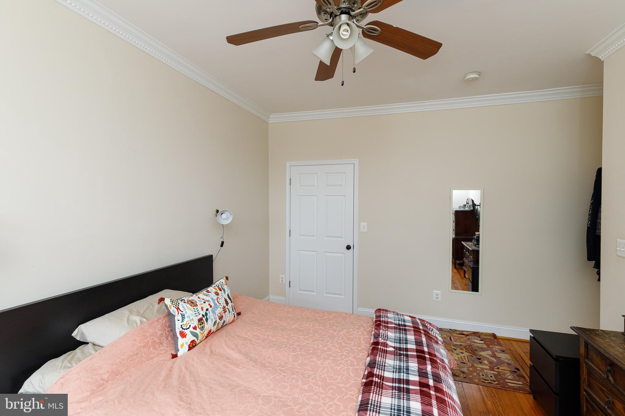 1113 Clifton Street Northwest Washington, DC 20009 - Photo 27 of 44 a bedroom with a bed and a painting on the wall