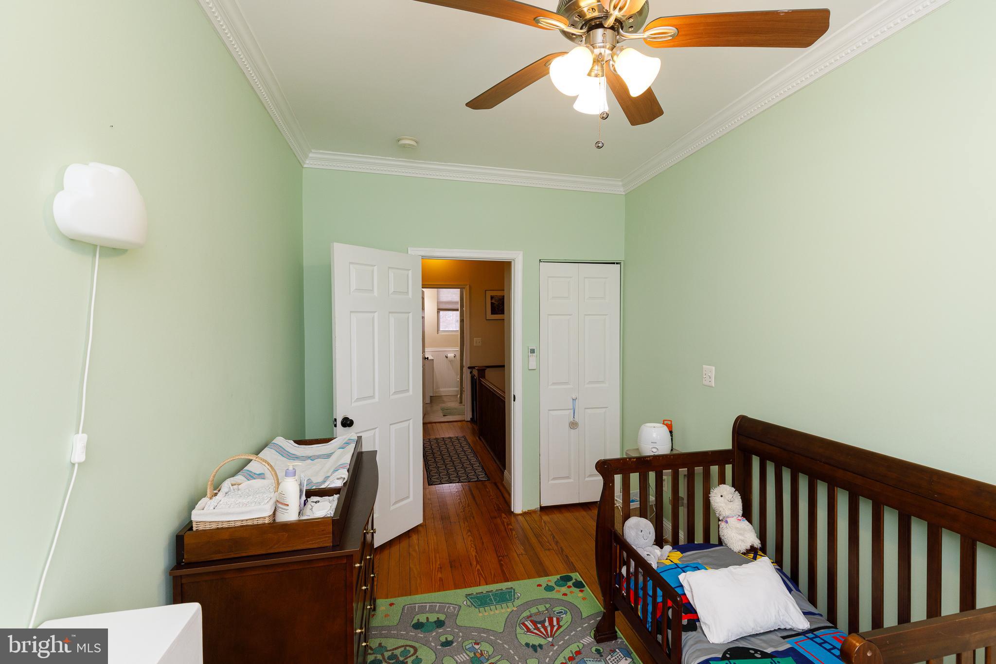 1113 Clifton Street Northwest Washington, DC 20009 - Photo 28 of 44 a bedroom with furniture and a chandelier fan