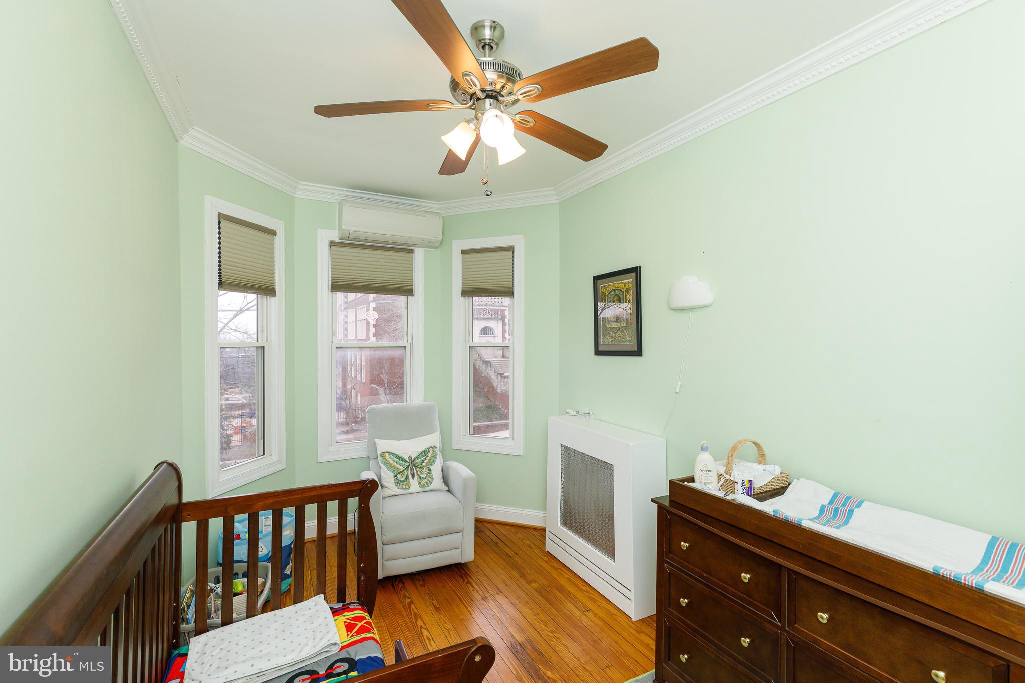 1113 Clifton Street Northwest Washington, DC 20009 - Photo 29 of 44 a bed room with a bed and a window