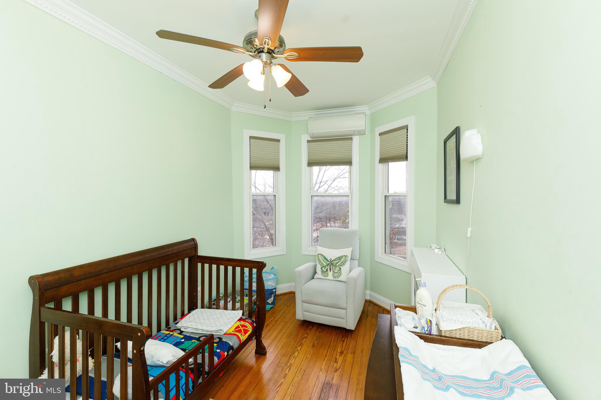 1113 Clifton Street Northwest Washington, DC 20009 - Photo 30 of 44 a bedroom with furniture and a large window