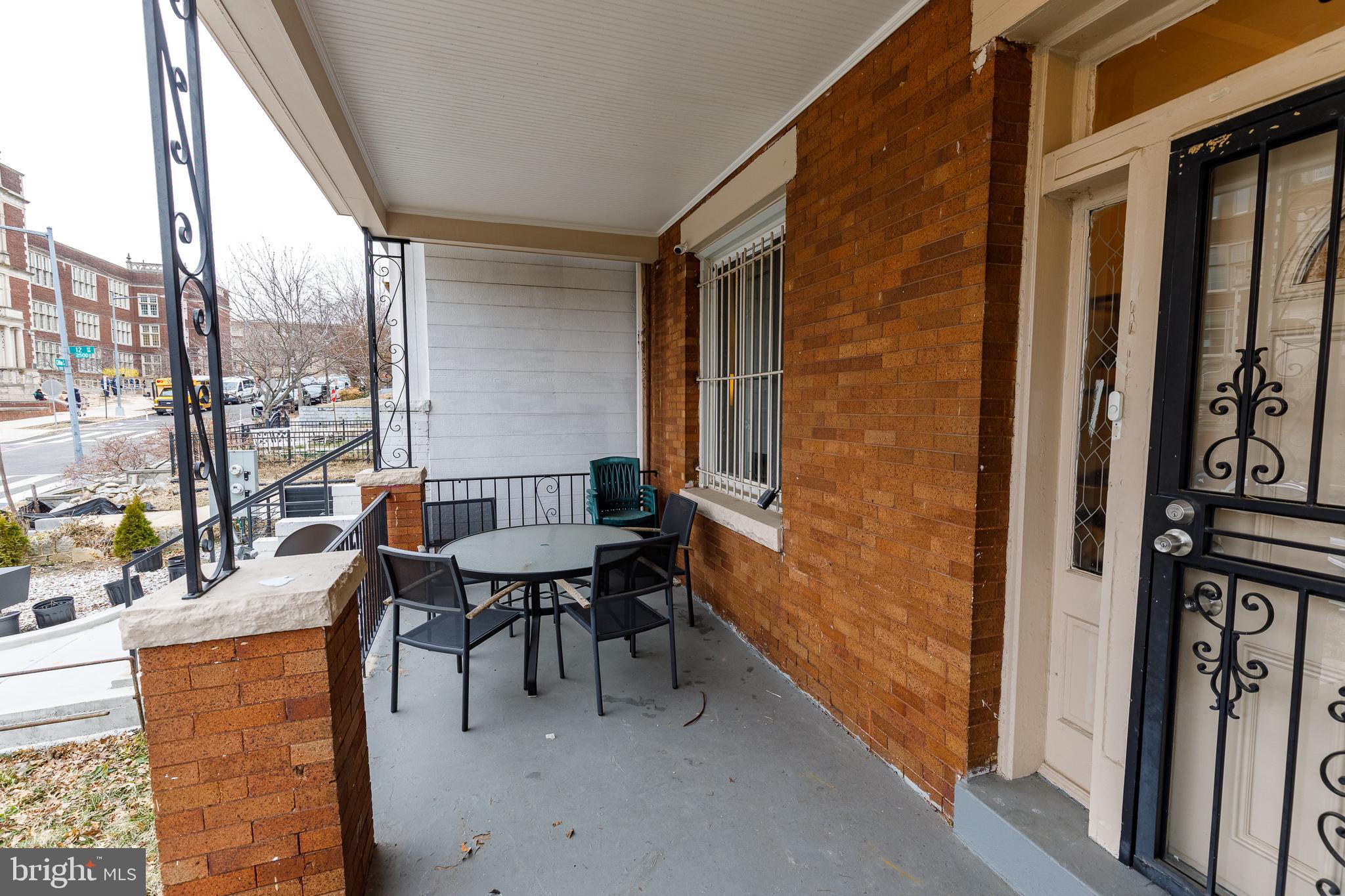 1113 Clifton Street Northwest Washington, DC 20009 - Photo 3 of 44 a balcony with chairs and table