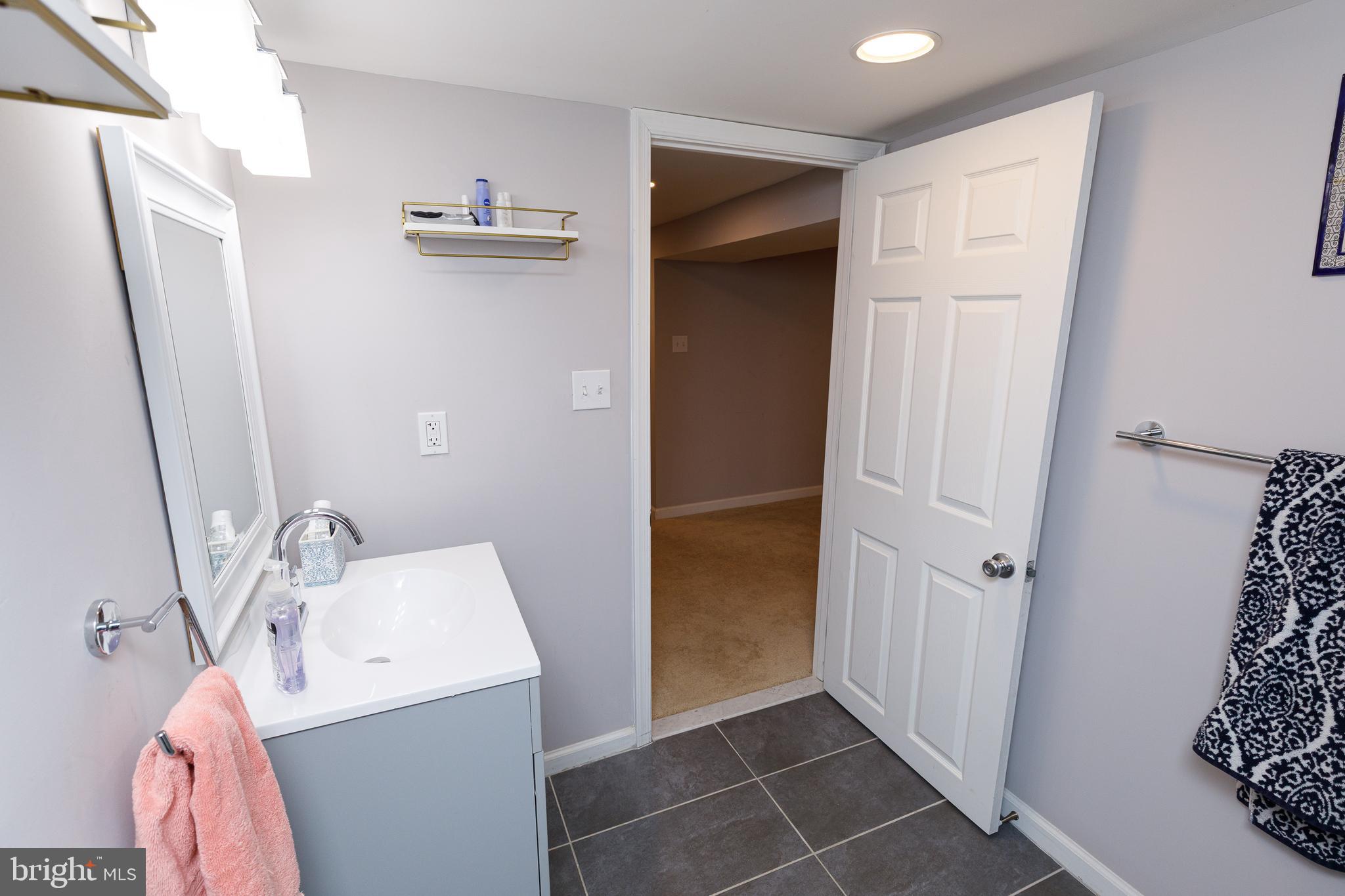 1113 Clifton Street Northwest Washington, DC 20009 - Photo 40 of 44 a bathroom with a sink and mirror