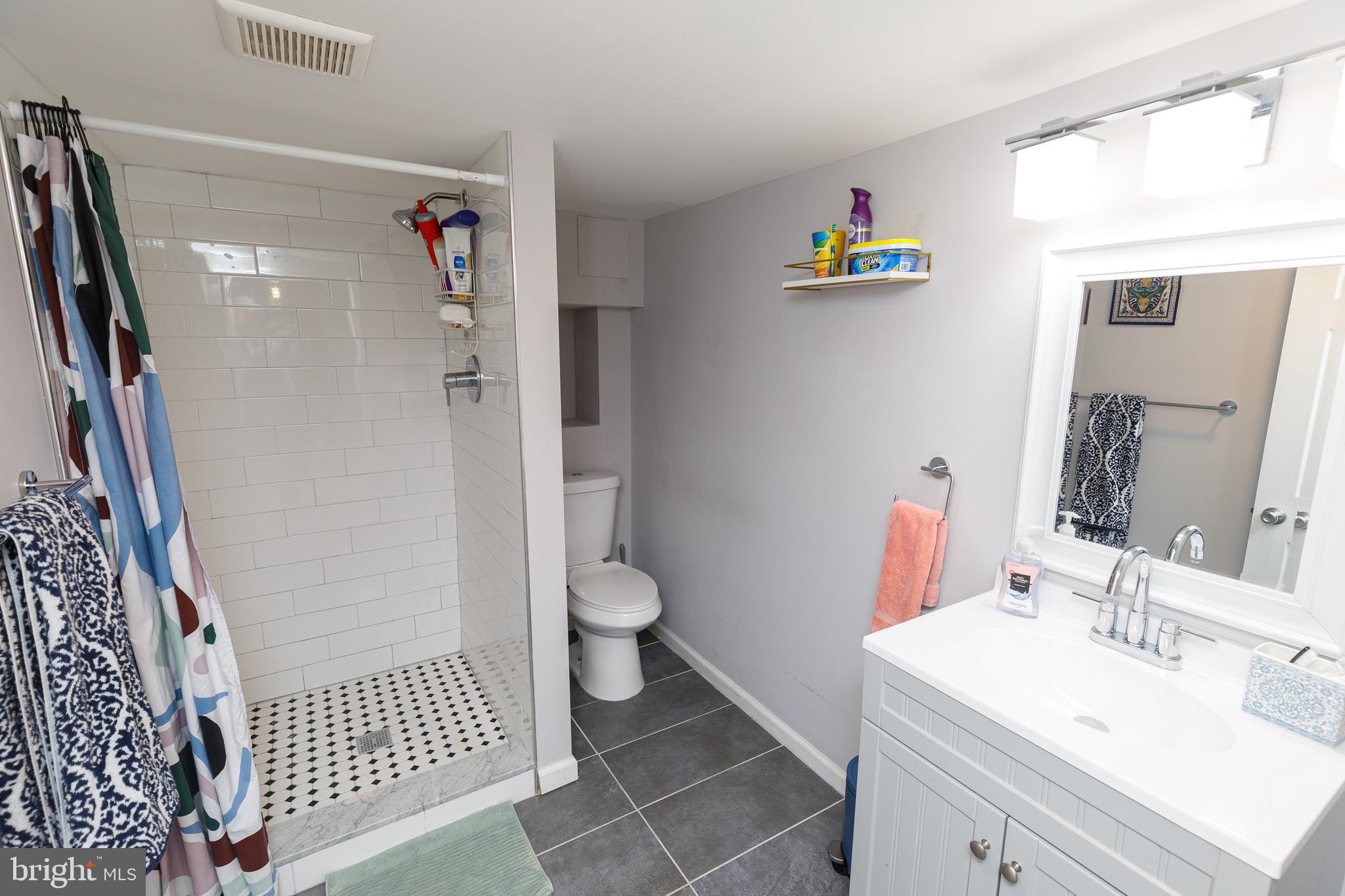 1113 Clifton Street Northwest Washington, DC 20009 - Photo 41 of 44 a bathroom with a sink toilet and a shower