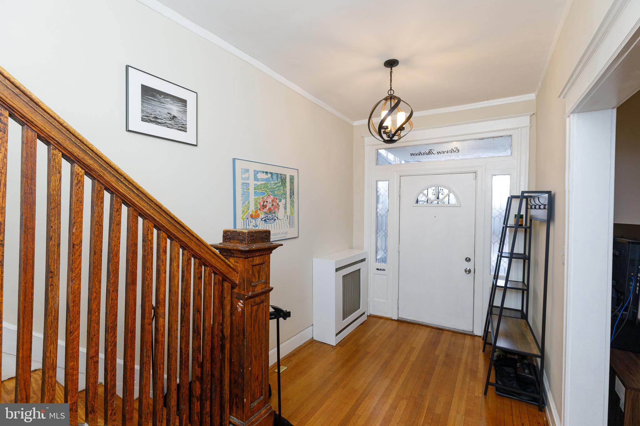 1113 Clifton Street Northwest Washington, DC 20009 - Photo 5 of 44 a view of a hallway with wooden floor and staircase