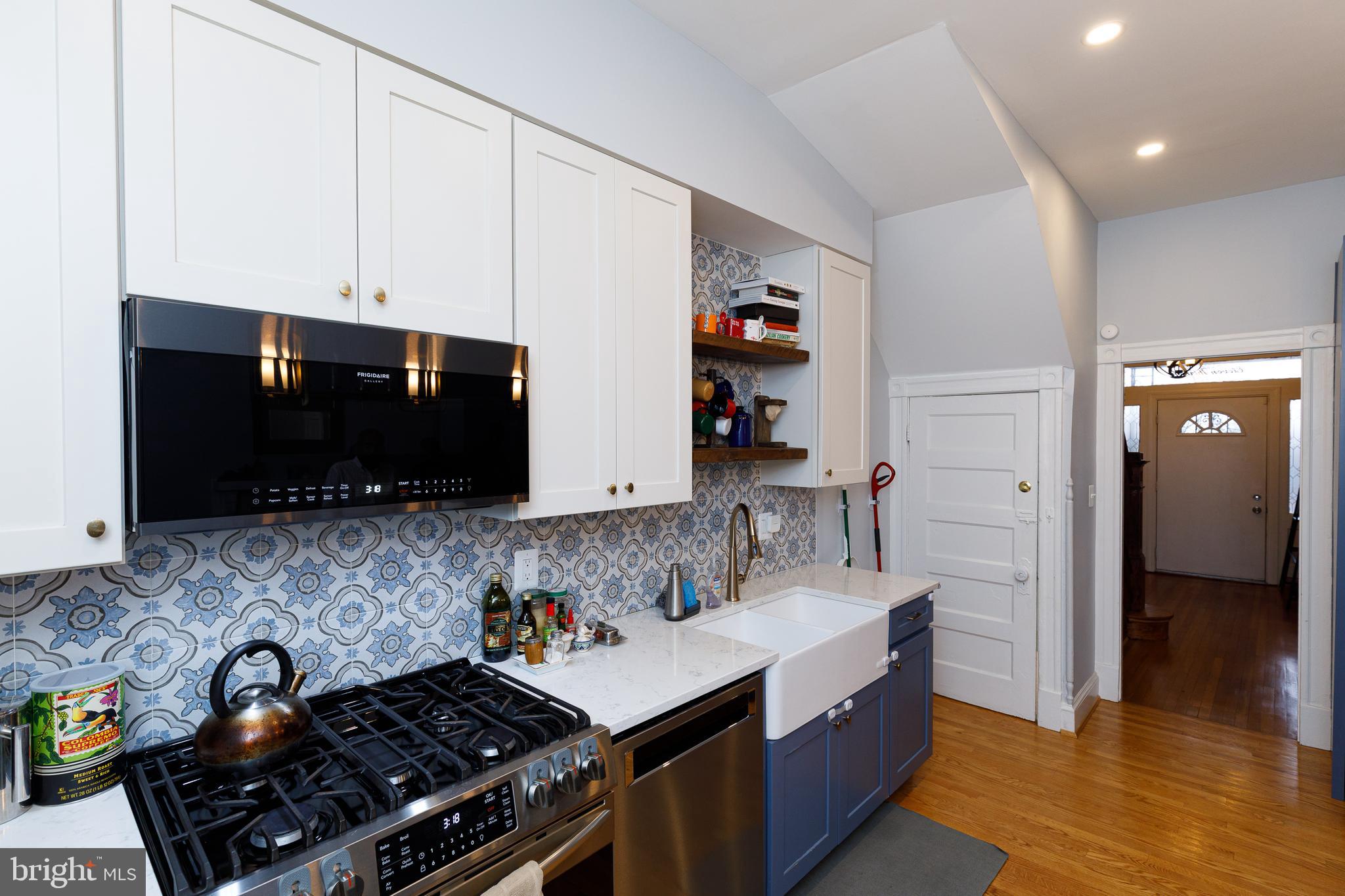 1113 Clifton Street Northwest Washington, DC 20009 - Photo 9 of 44 a kitchen with stainless steel appliances a stove a sink and a microwave