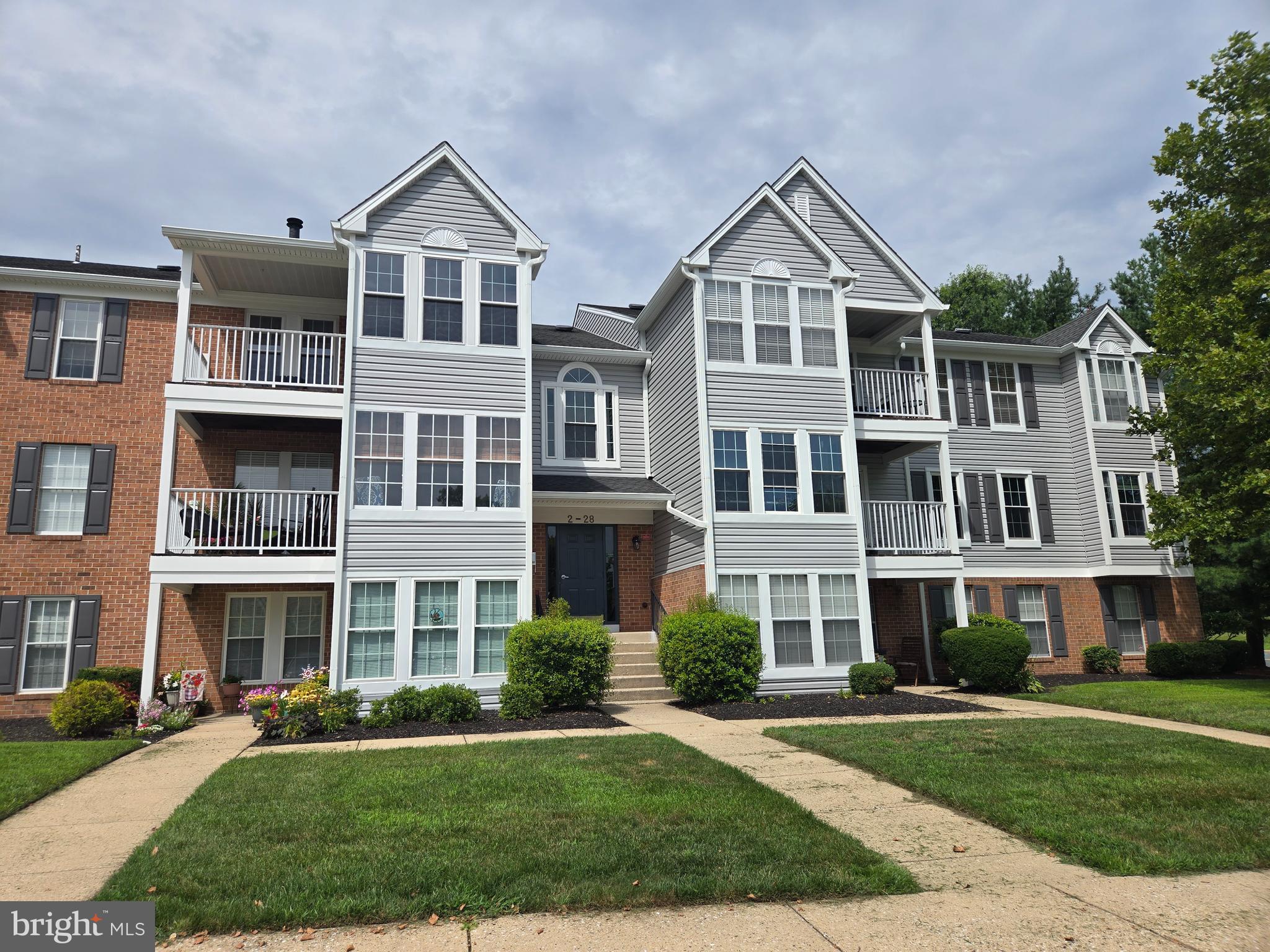 16 Laurel Path Court, Unit 1 Baltimore, MD 21236 - Photo 1 of 28 a front view of a residential apartment building with a yard