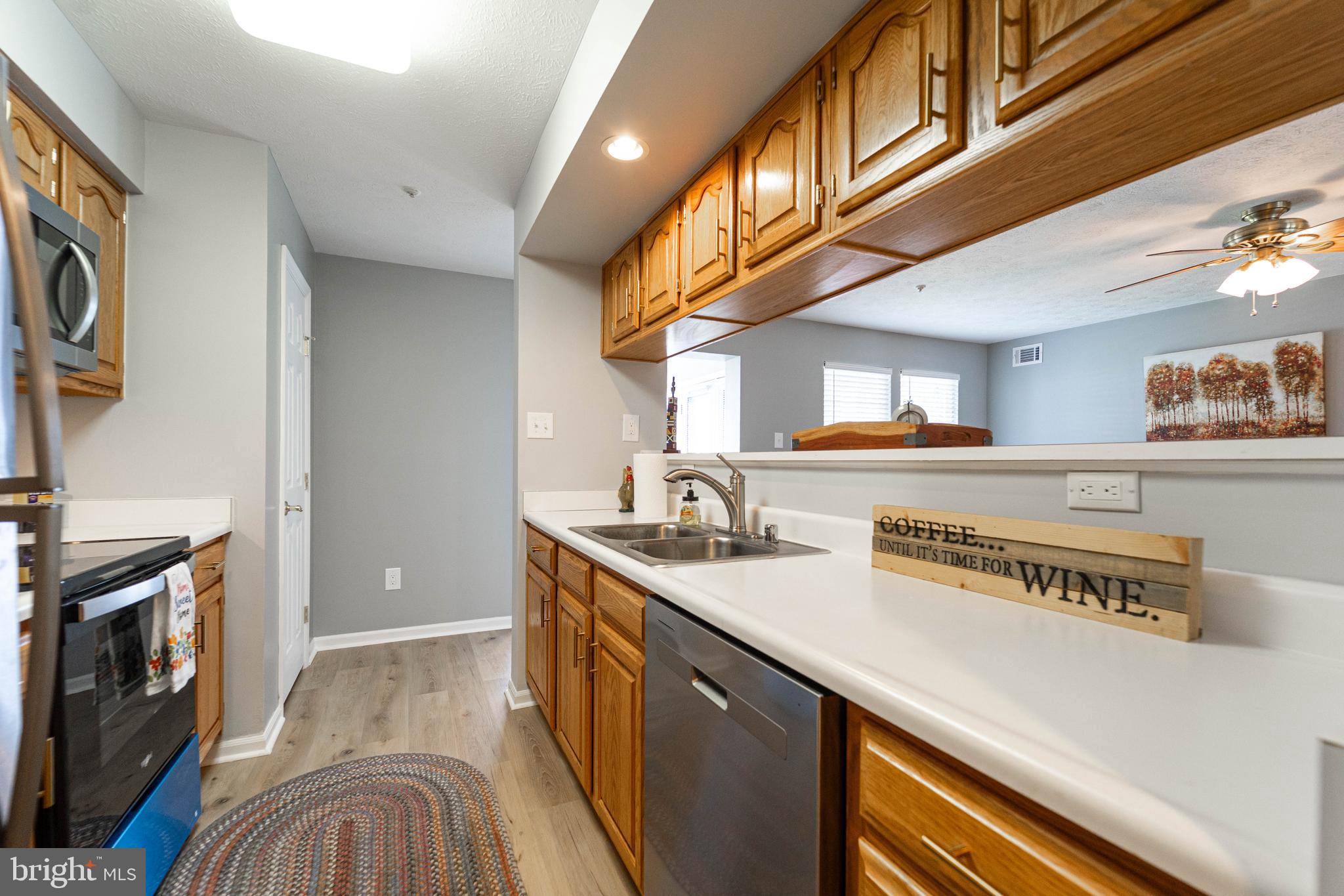 16 Laurel Path Court, Unit 1 Baltimore, MD 21236 - Photo 11 of 28 a kitchen with stainless steel appliances granite countertop a sink a stove and a wooden floors