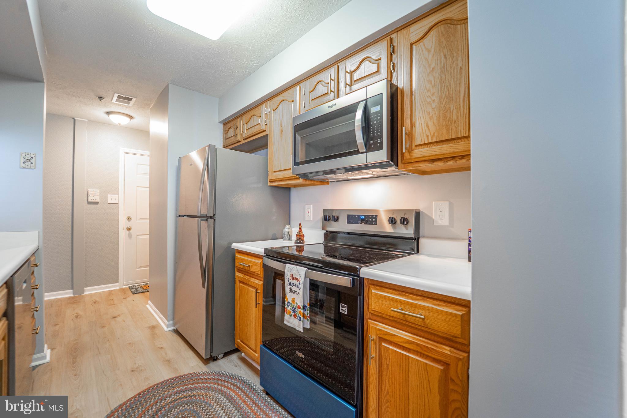 16 Laurel Path Court, Unit 1 Baltimore, MD 21236 - Photo 12 of 28 a kitchen with stainless steel appliances granite countertop a stove a refrigerator and a microwave