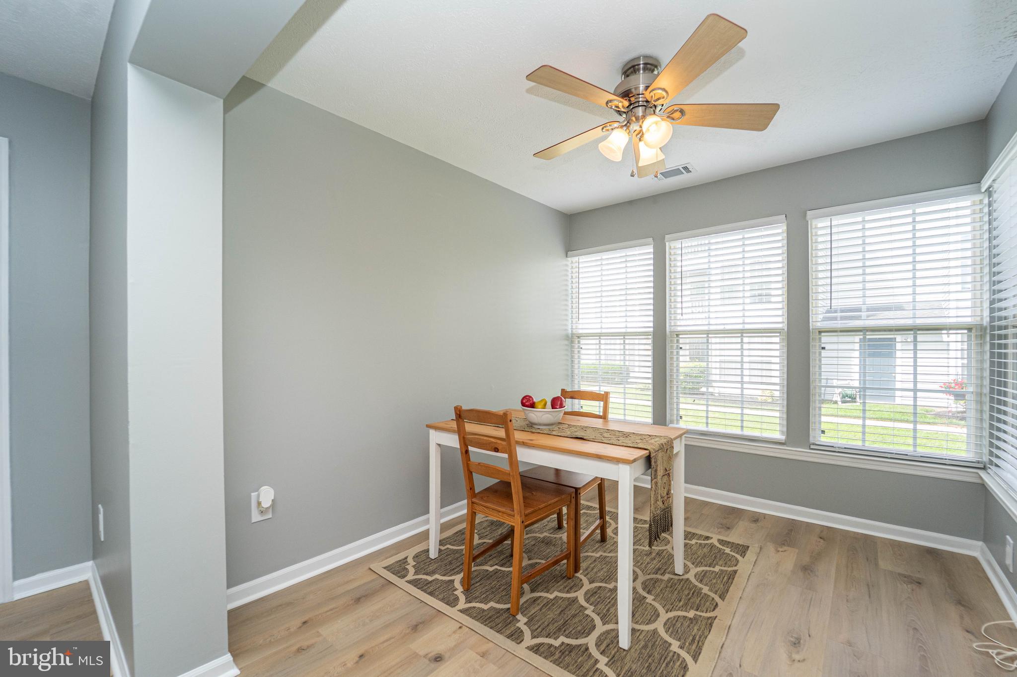 16 Laurel Path Court, Unit 1 Baltimore, MD 21236 - Photo 15 of 28 a dining room with chandelier fan and wooden floor