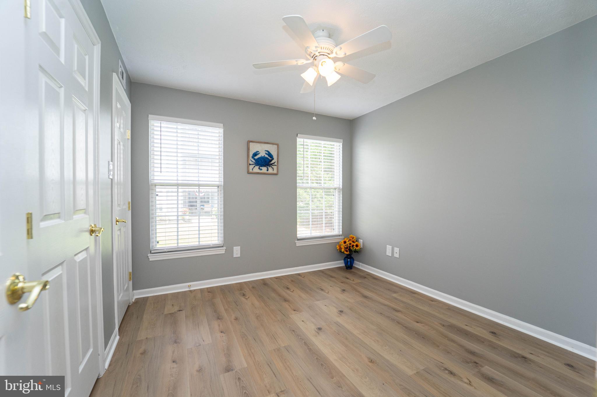 16 Laurel Path Court, Unit 1 Baltimore, MD 21236 - Photo 19 of 28 an empty room with wooden floor and windows