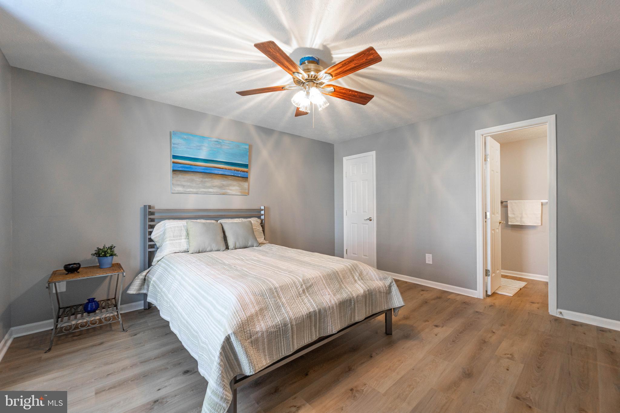16 Laurel Path Court, Unit 1 Baltimore, MD 21236 - Photo 23 of 28 a bedroom with bed and a chandelier
