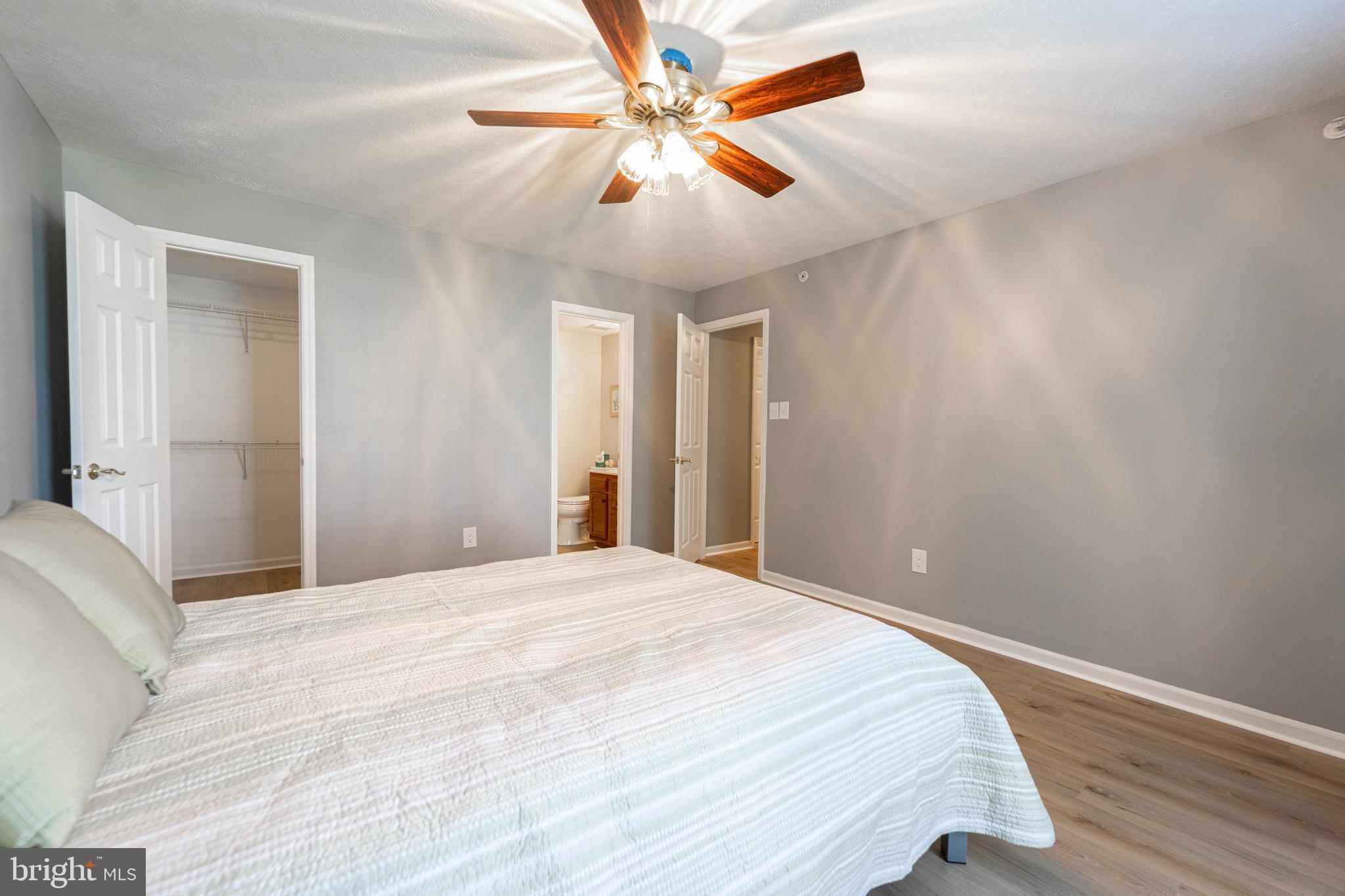 16 Laurel Path Court, Unit 1 Baltimore, MD 21236 - Photo 24 of 28 a bedroom with a bed and a chandelier
