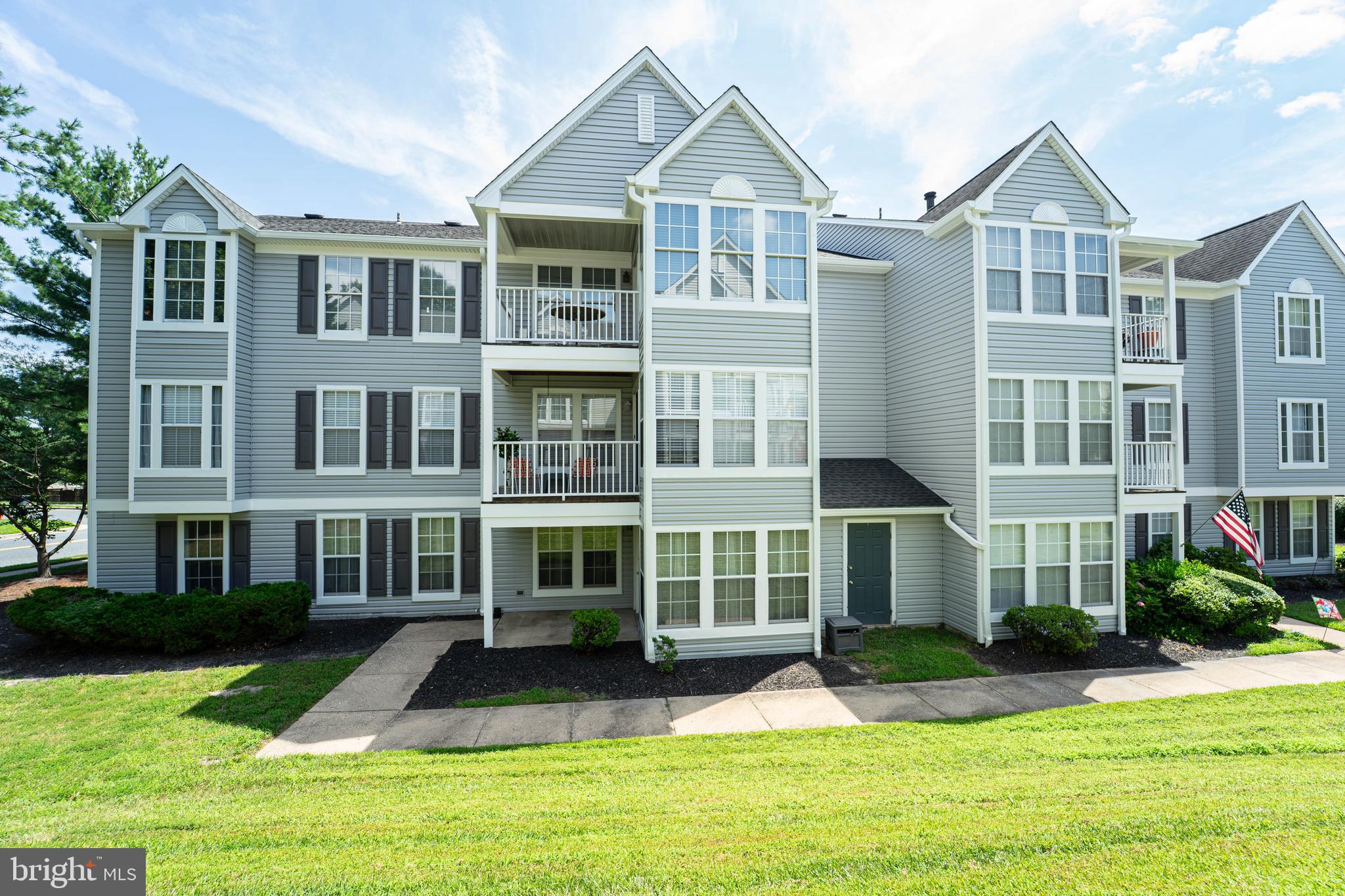 16 Laurel Path Court, Unit 1 Baltimore, MD 21236 - Photo 3 of 28 a front view of a residential apartment building with a yard