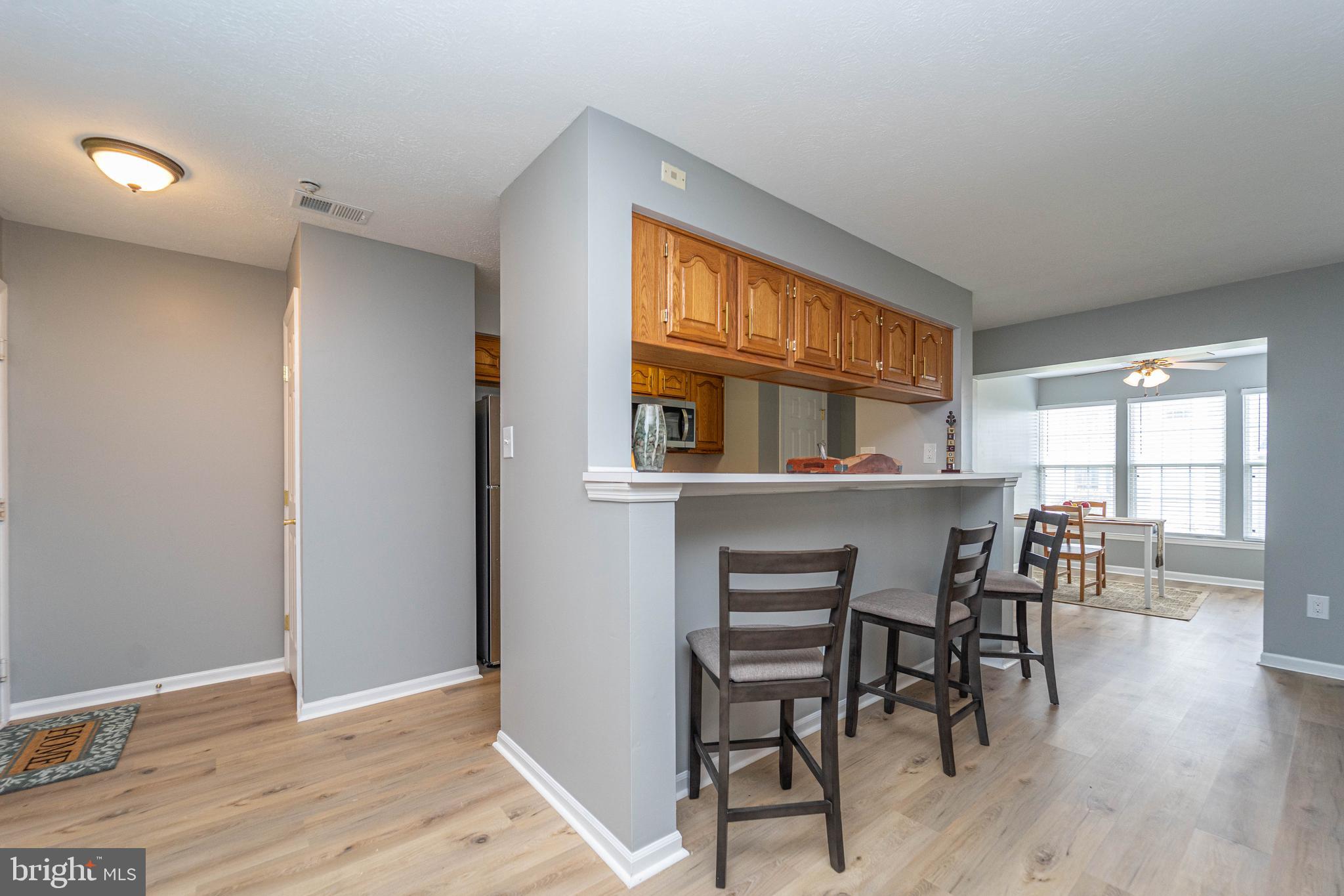16 Laurel Path Court, Unit 1 Baltimore, MD 21236 - Photo 7 of 28 a dining room with furniture and wooden floor