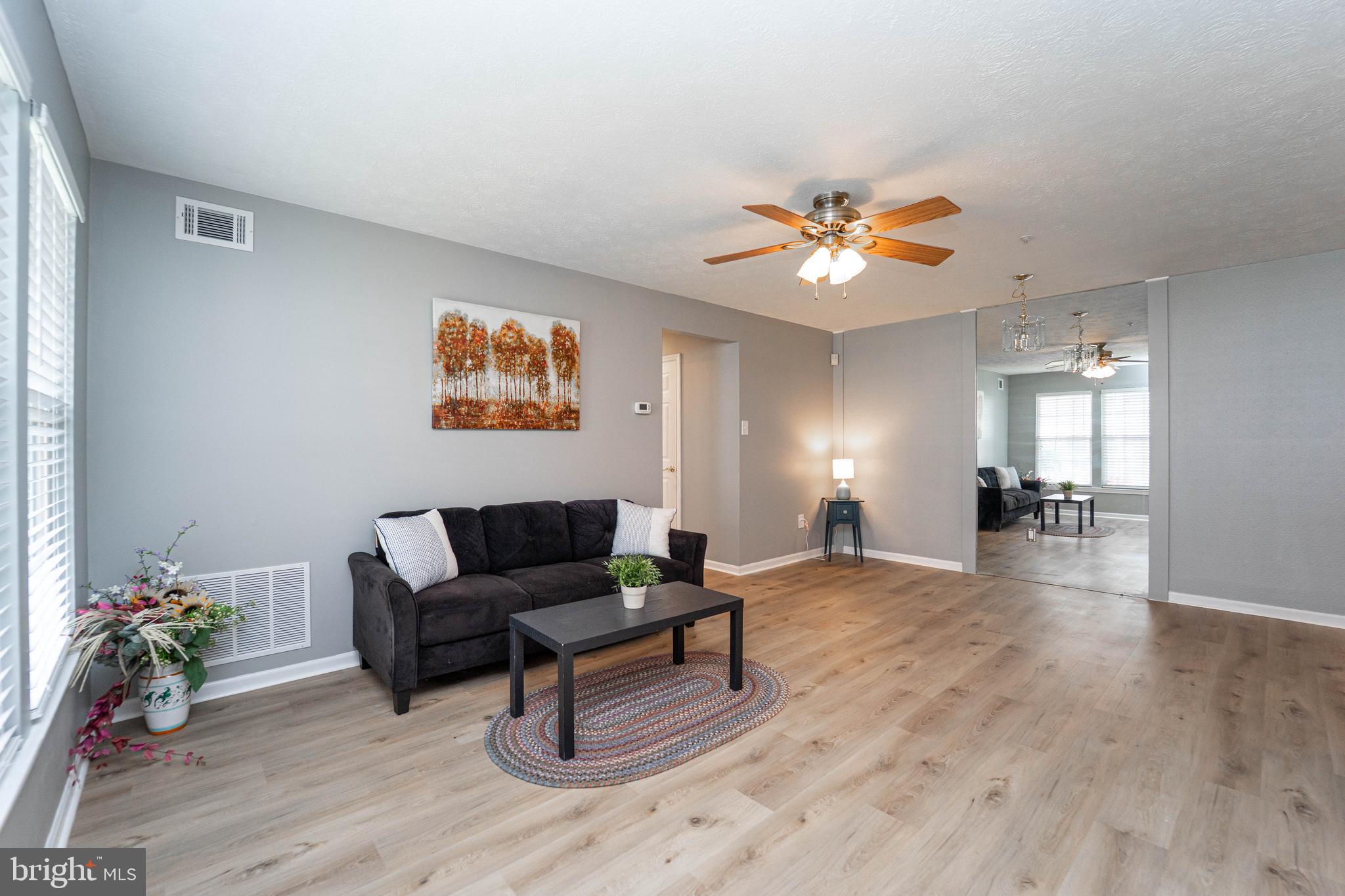16 Laurel Path Court, Unit 1 Baltimore, MD 21236 - Photo 8 of 28 a living room with furniture and wooden floor