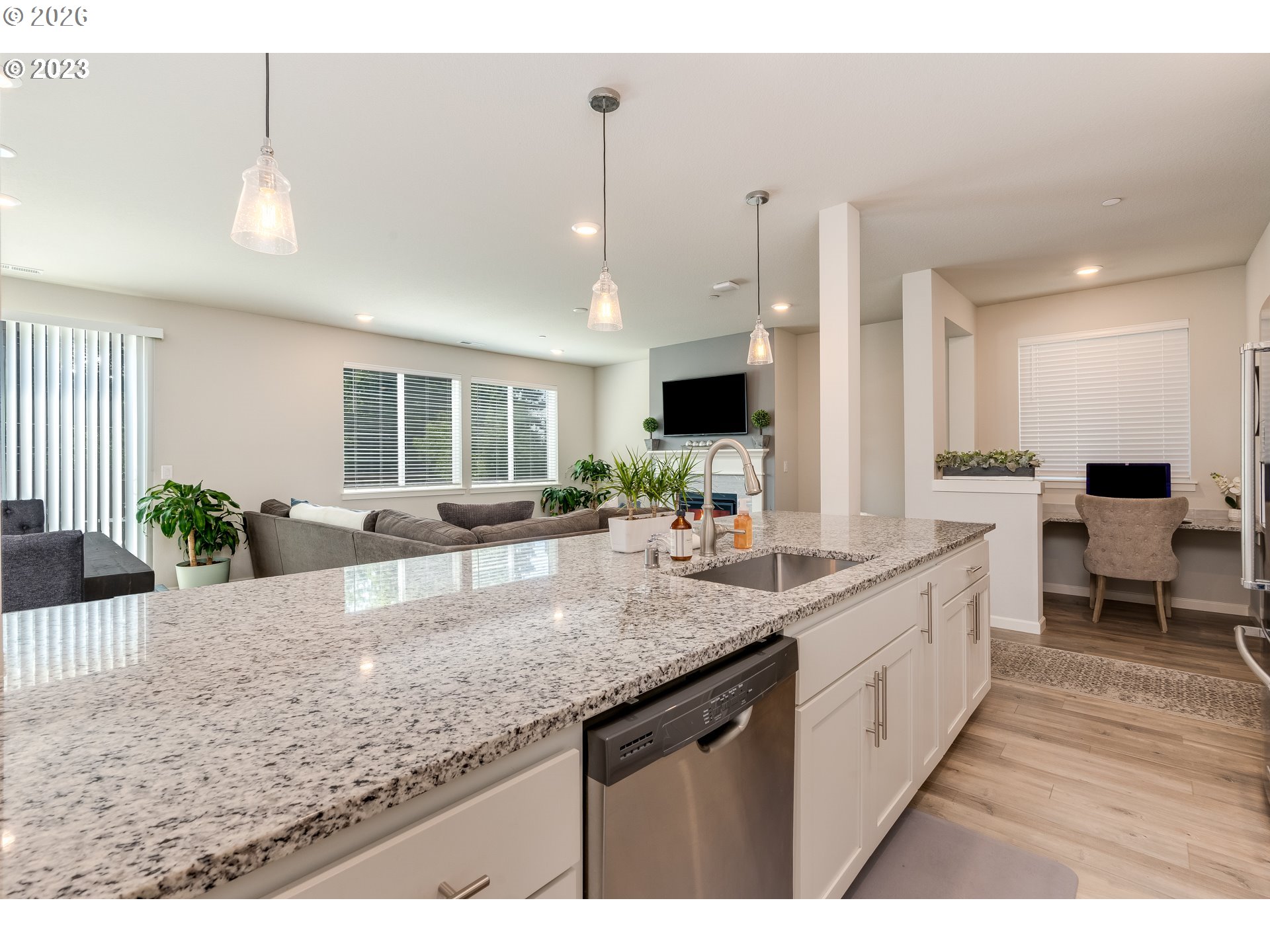 6150 North 86th Avenue Camas, WA 98607 - Photo 15 of 41 a large kitchen with kitchen island granite countertop a sink counter space and living room view