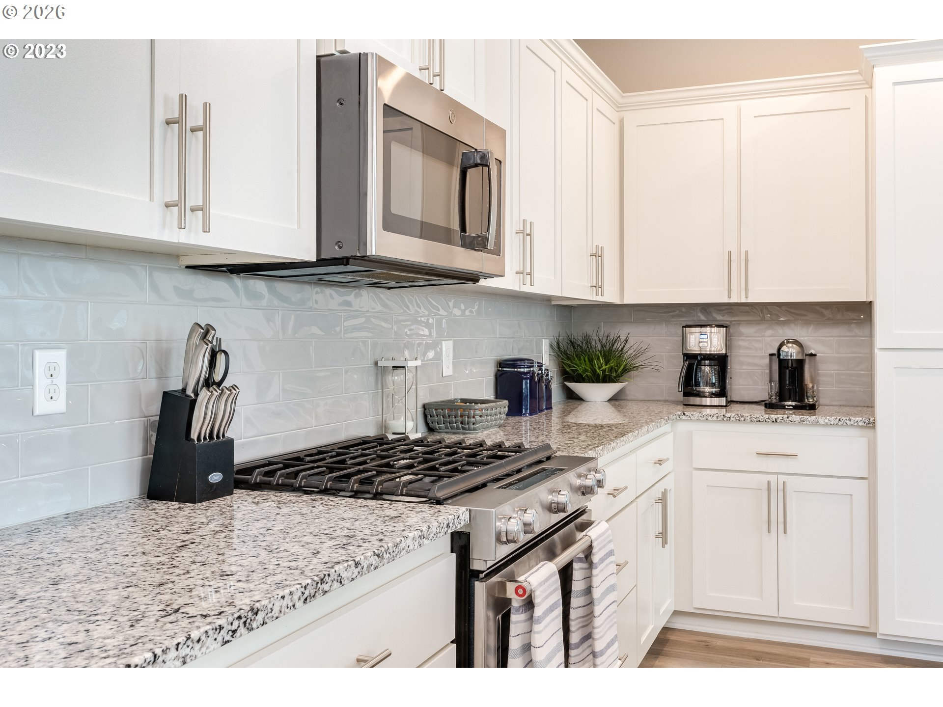 6150 North 86th Avenue Camas, WA 98607 - Photo 17 of 41 a kitchen with stainless steel appliances granite countertop a stove a sink dishwasher and cabinets with wooden floor