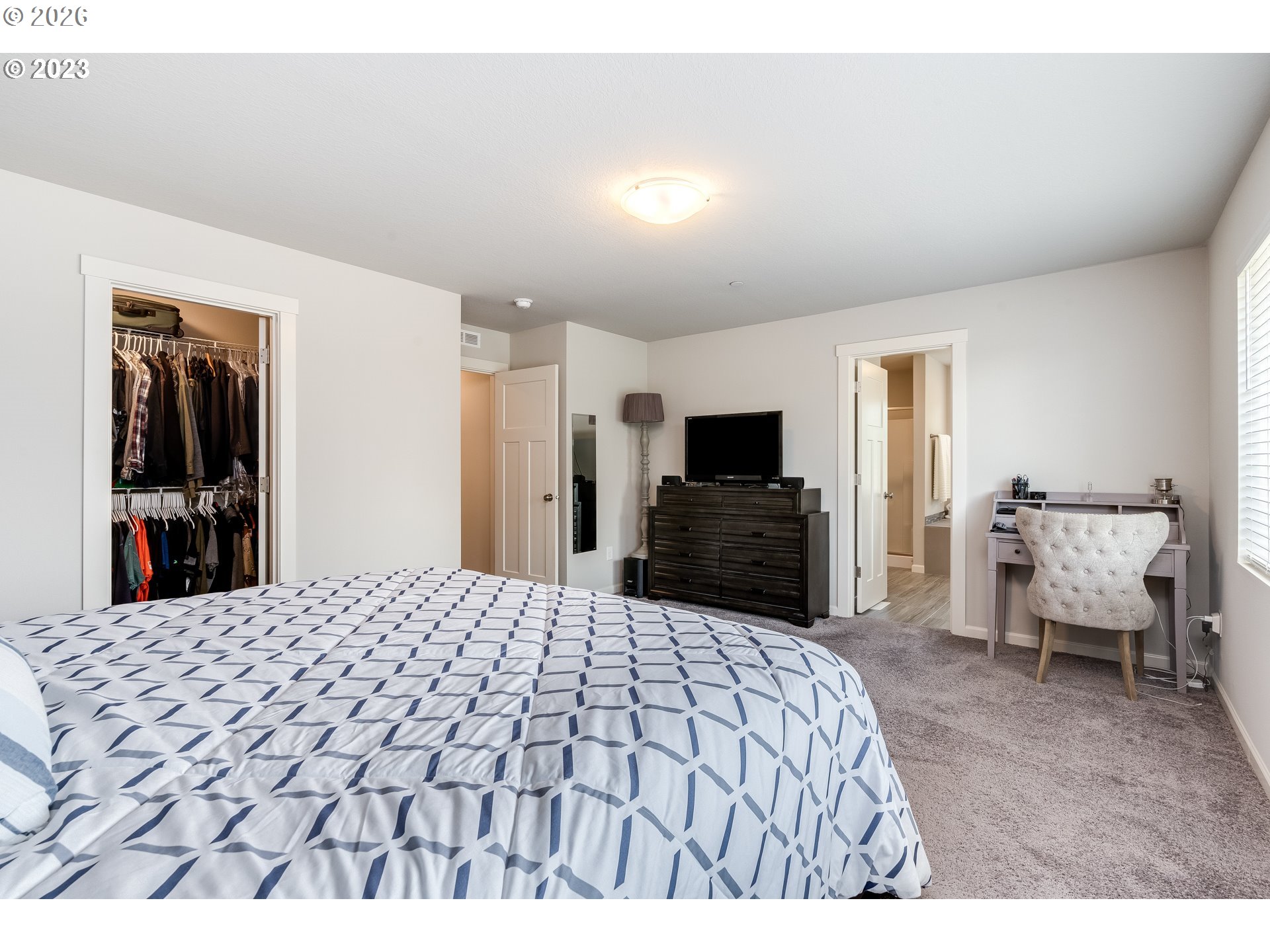 6150 North 86th Avenue Camas, WA 98607 - Photo 30 of 41 a large bedroom with a bed and a flat screen tv