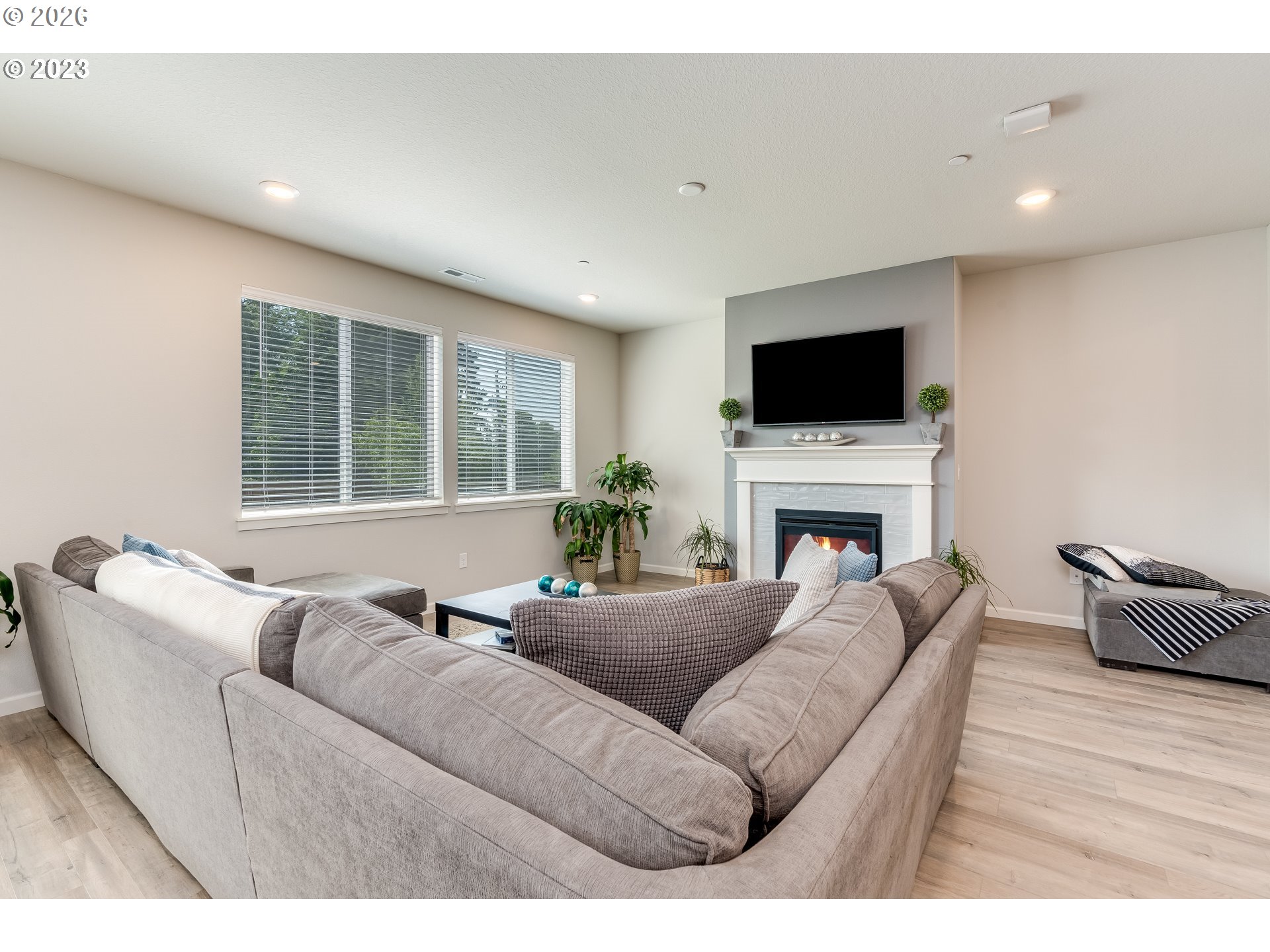 6150 North 86th Avenue Camas, WA 98607 - Photo 9 of 41 a living room with furniture a flat screen tv and a fireplace