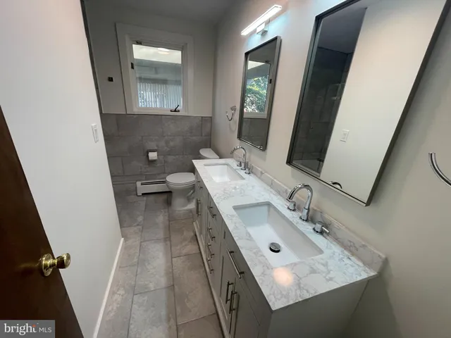 a bathroom with a sink vanity and mirror